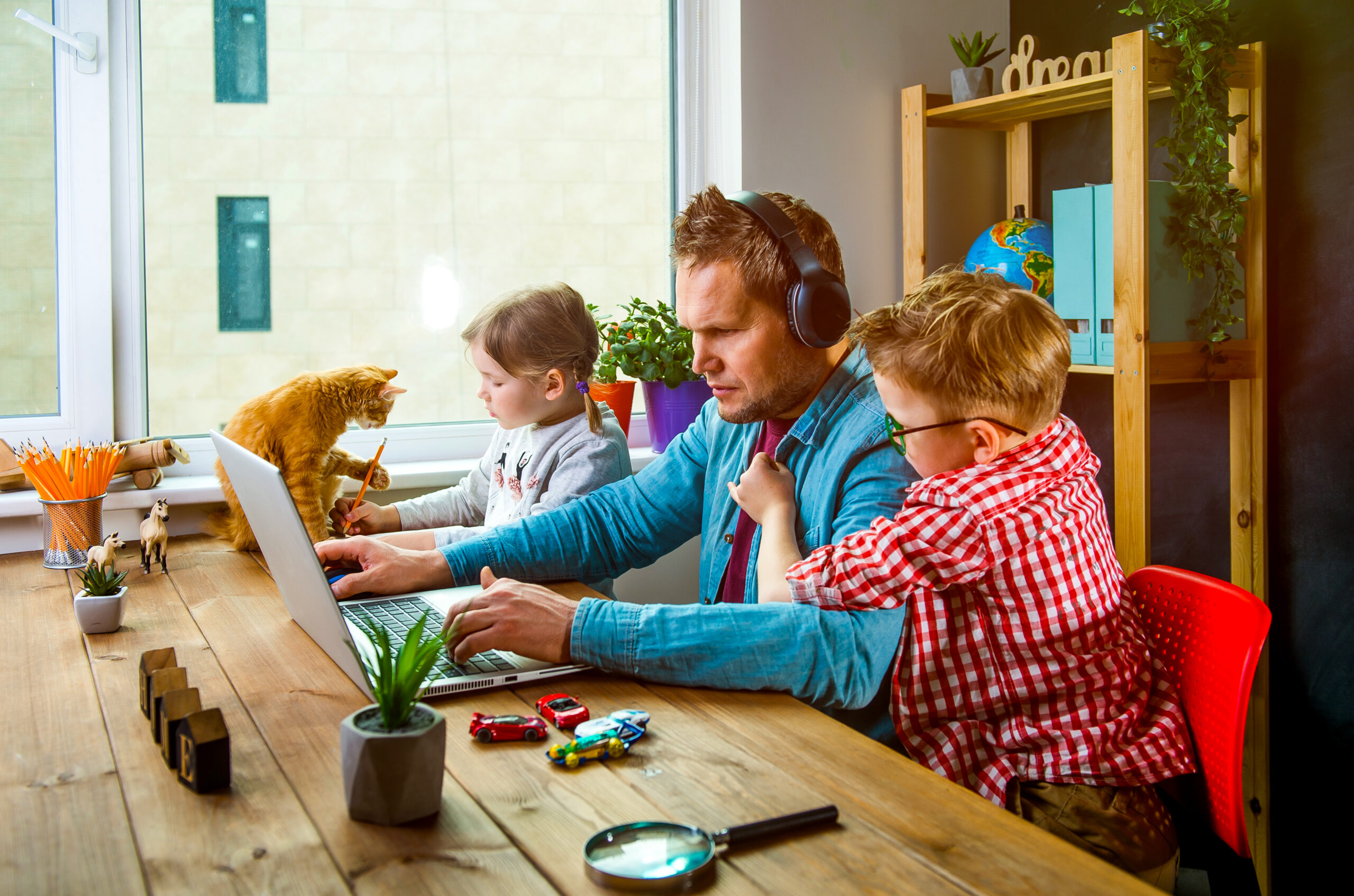 Work,From,Home.,Man,Works,On,Laptop,With,Children,Playing